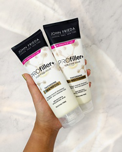 Hand holding a set of PROfiller+ products against a marble background